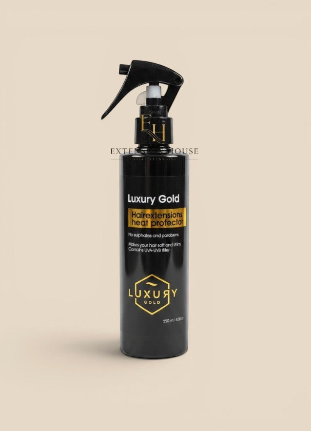 Extension house Luxury Gold hittebeschermende spray voor hairextensions in zwarte fles met gouden details.
