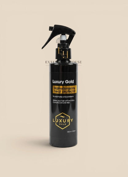 Extension house Luxury Gold hittebeschermende spray voor hairextensions in zwarte fles met gouden details.