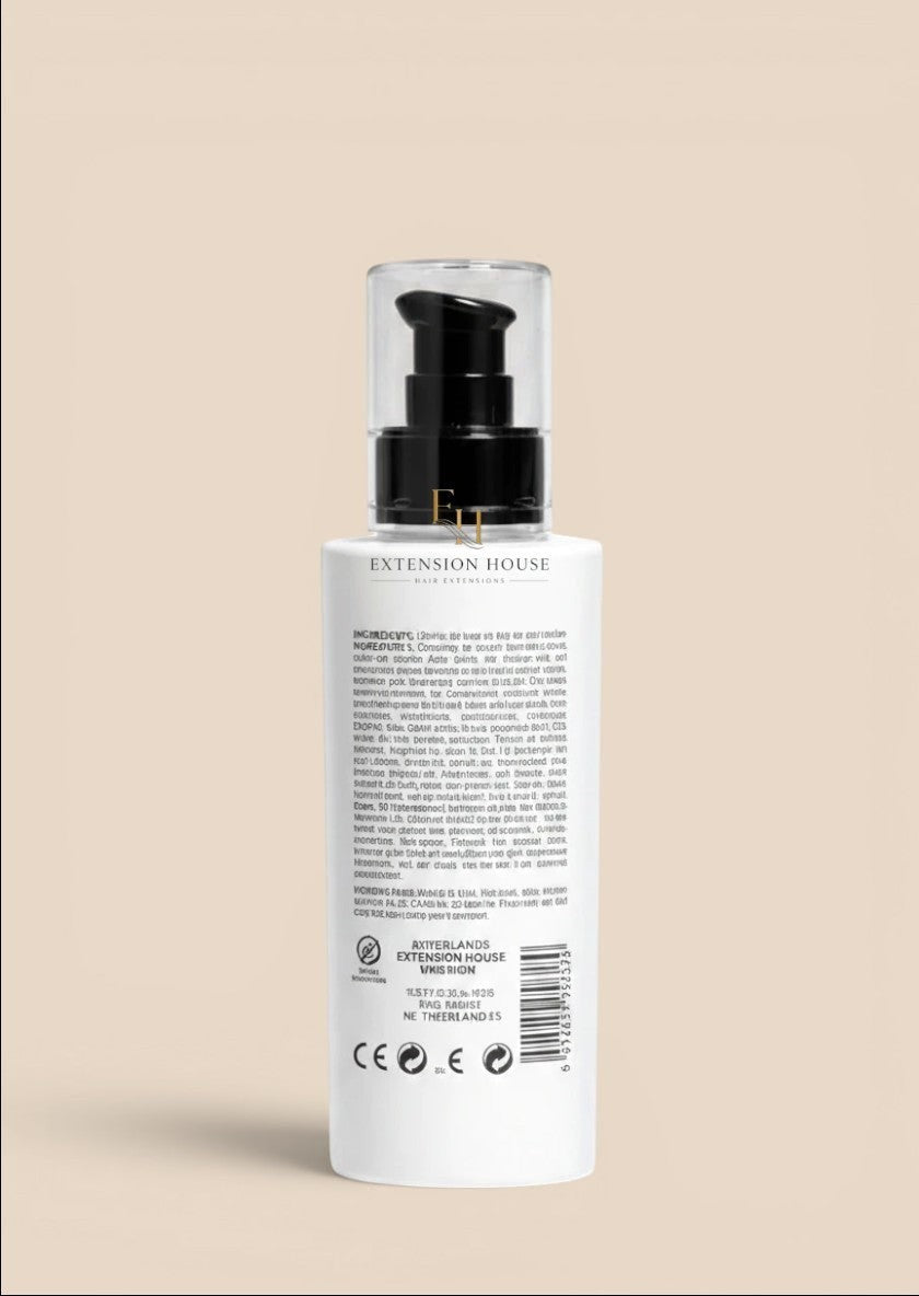 Achterkant van de witte MOHI 10 in 1 Absolute Repair leave-in spray fles van Extension house met zwarte pomp.