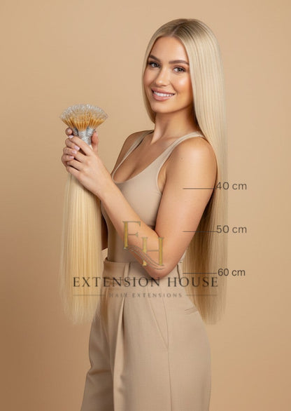 Extension House #60 Nanoring extensions van 100% echt haar in zonnig blond, 40-60 cm lang. Model toont volume en lengte.