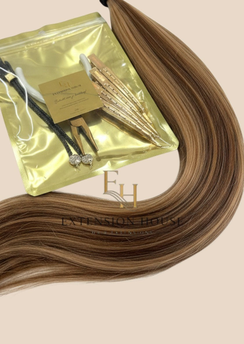 Extension House nanoring extensions in #24/8 honey blonde highlight blend, een mix van lichtbruin en blonde highlights.
